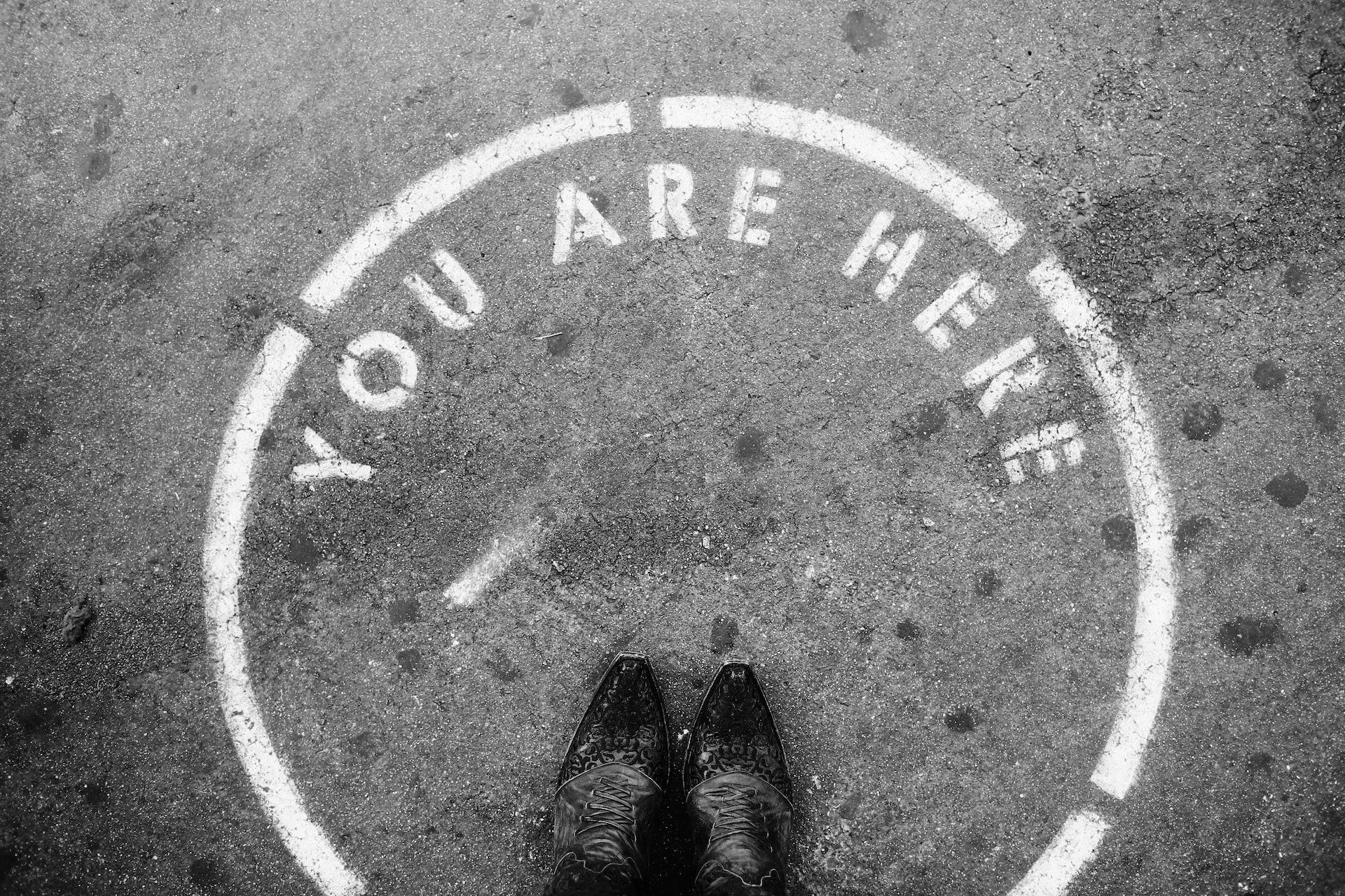 person wearing black leather shoes
